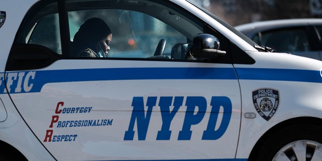 NYPD officer in marked vehicle