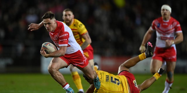 St Helens player breaks a tackle 