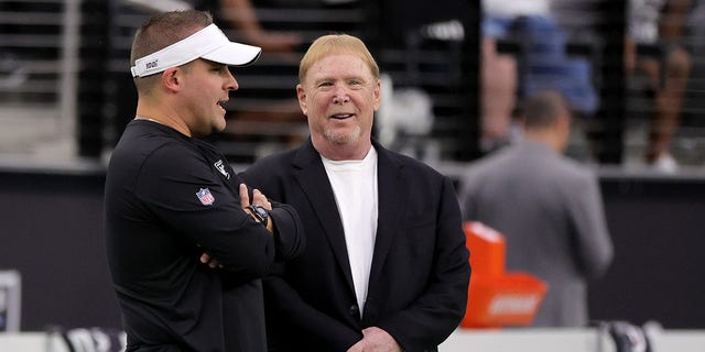 Mark Davis stands with Raiders head coach Josh McDaniels