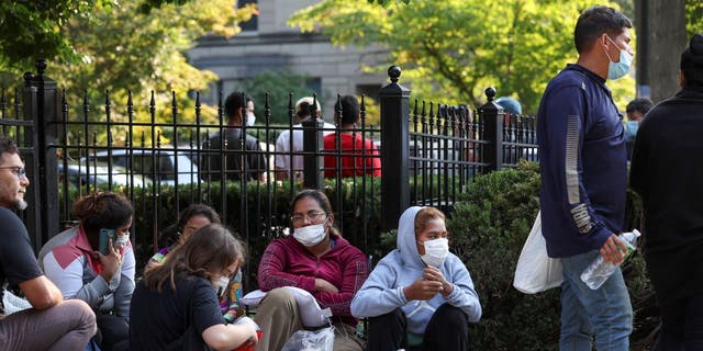 Migrants sitting outside VP's house