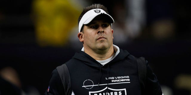 Raiders head coach Josh McDaniels takes the field before the Saints game.