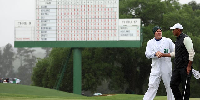 Tiger Woods and Joe LaCava walk the green at Augusta National