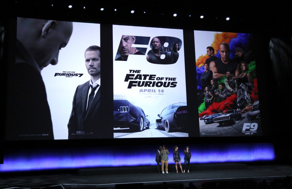 Cast members in the upcoming "Fast X" stand underneath posters of previous films in the "Fast and the Furious" franchise during the Universal Pictures and Focus Features presentation at CinemaCon on April 26, 2023, in Las Vegas. 
