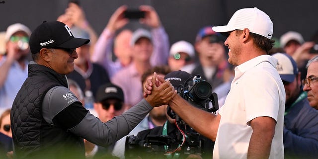 Claude Harmon III congratulates Brooks Koepka after winning to the 2023 PGA Championship