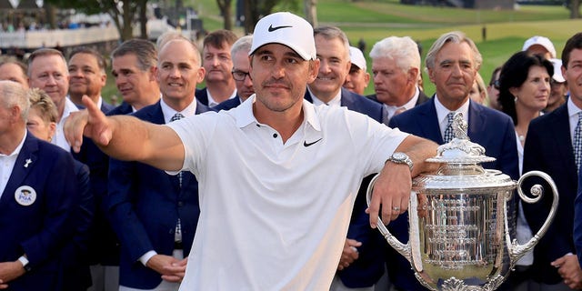 Brooks Koepka poses with the PGA Championship trophy