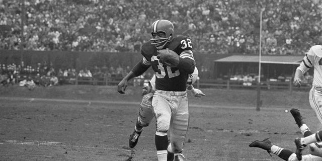 Jim Brown runs for a first down