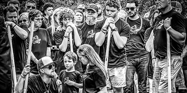 The Guffey family gathers at Gavin's funeral holding shovles