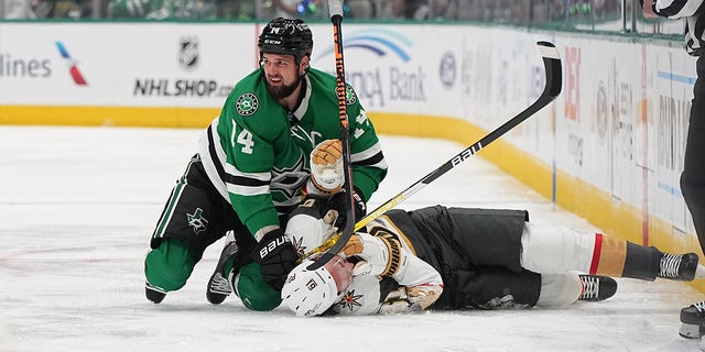 Jamie Benn cross-checks Mark Stone