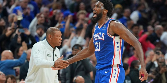 Joel Embiid and Doc Rivers high five