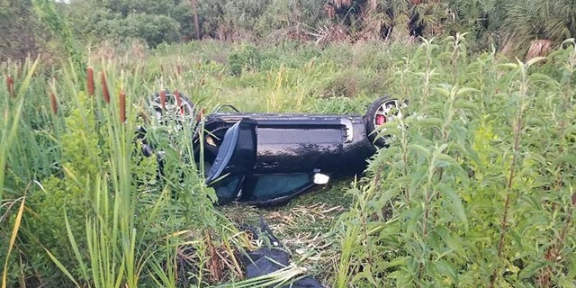 KIA flipped over in grass