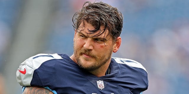 Taylor Lewan squints with helmet off