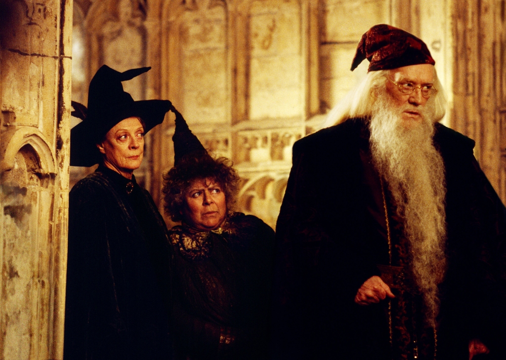 Richard Harris as Dumbledore (with Maggie Smith and Miriam Margolyes) in a scene from "Harry Potter and the Chamber of Secrets." He's got a long white beard.