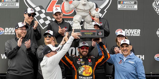 Martin Truex Jr holds the trophy