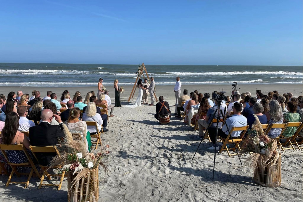 The Hutchinson's during their wedding ceremony on Folly Beach in South Carolina.