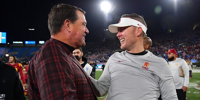 Mike Bohn celebrates with Lincoln Riley