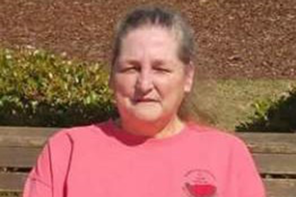 Past photo of Gloria Satterfield wearing a pink t-shirt, sitting on a bench outside