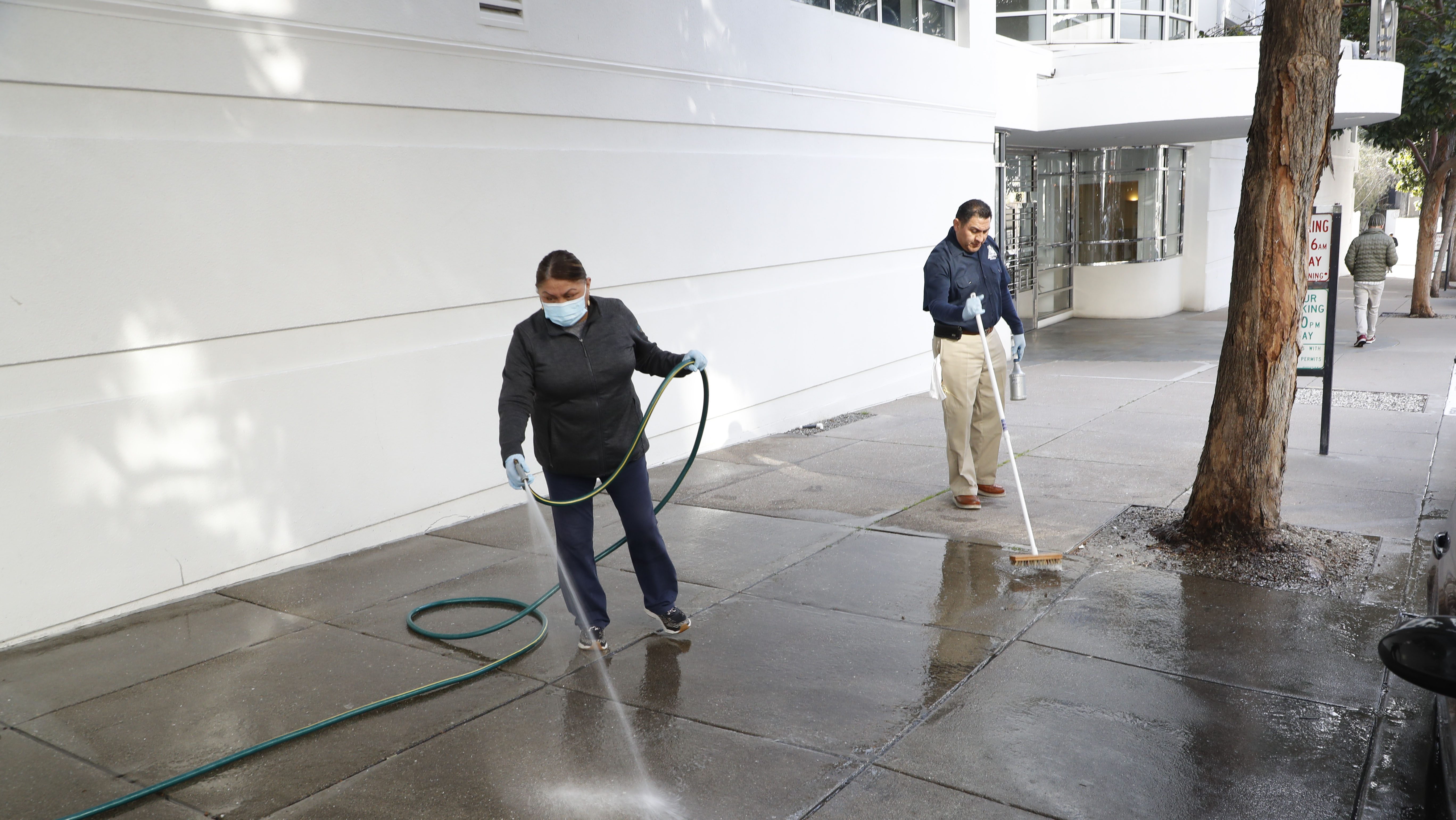 Workers clean the sidewalk area where tech executive Bob Lee was stabbed to death outside of 403 Main Street in San Francisco, Calif on Tuesday morning, April 4, 2023.