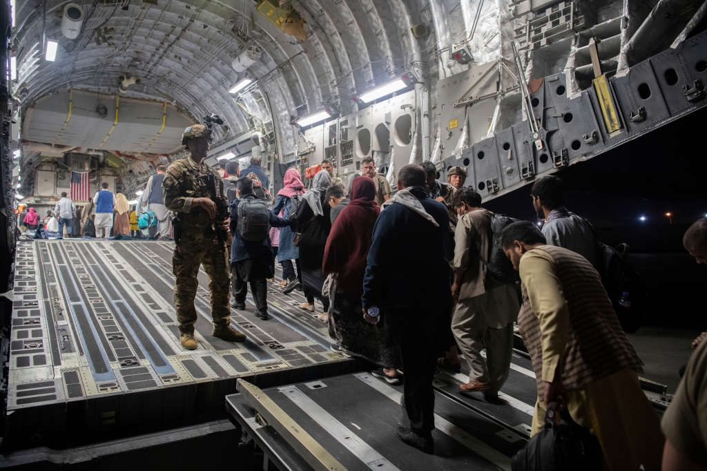 Afghan passengers boarding an Air Force plane in Kabul during the withdrawal on August 22, 2021.