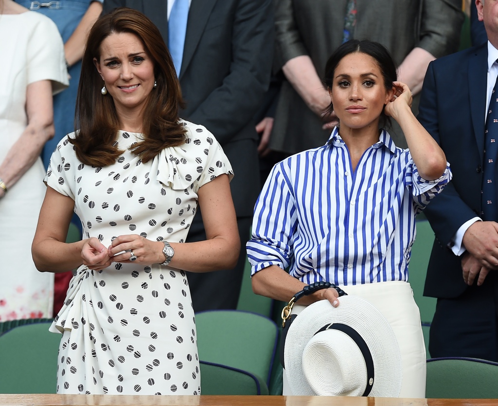 Kate Middleton and Megan Markle standing next to each other