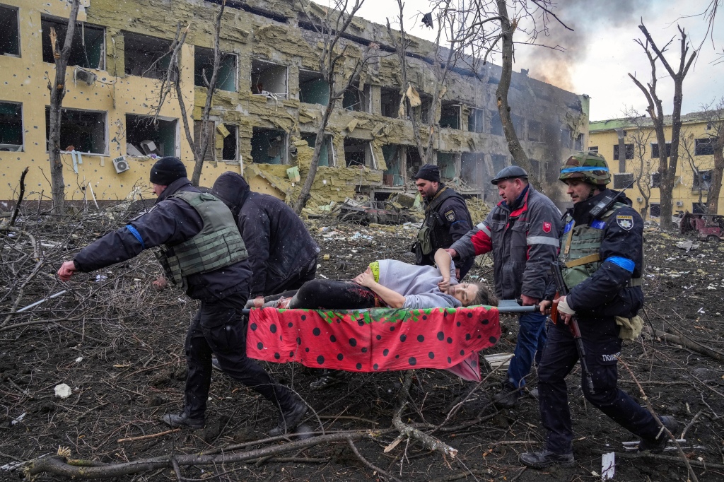 Iryna Kalinina, 32, a mortally injured pregnant woman, is carried from a maternity hospital that was damaged during a Russian airstrike in Mariupol, Ukraine, on March 9, 2022. 