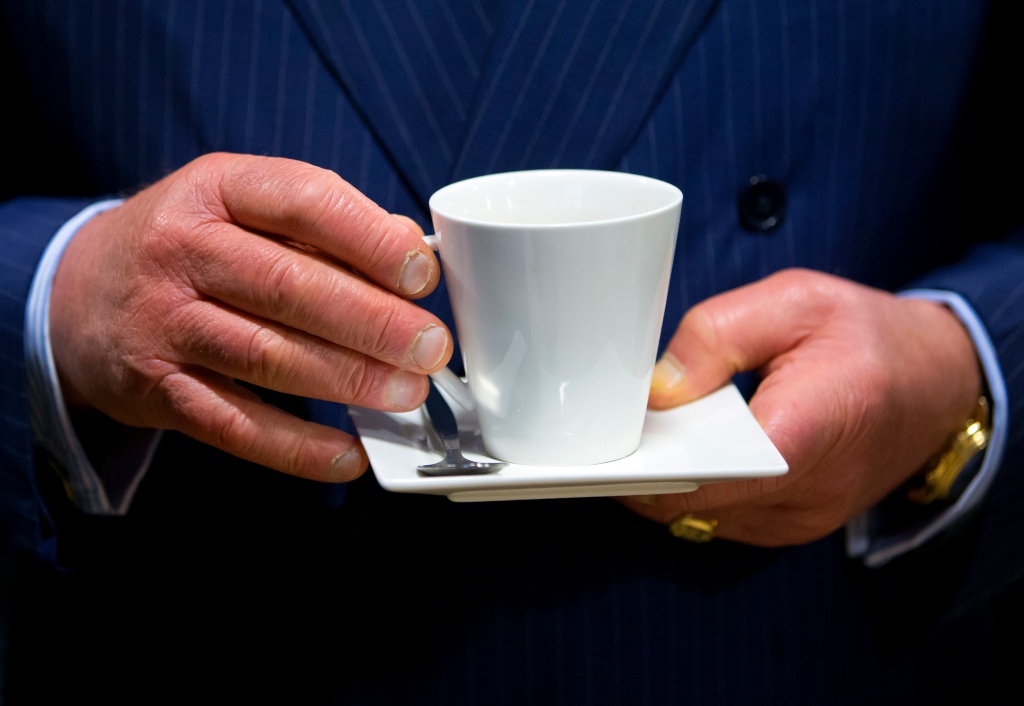 King Charles' hands holding tea cup