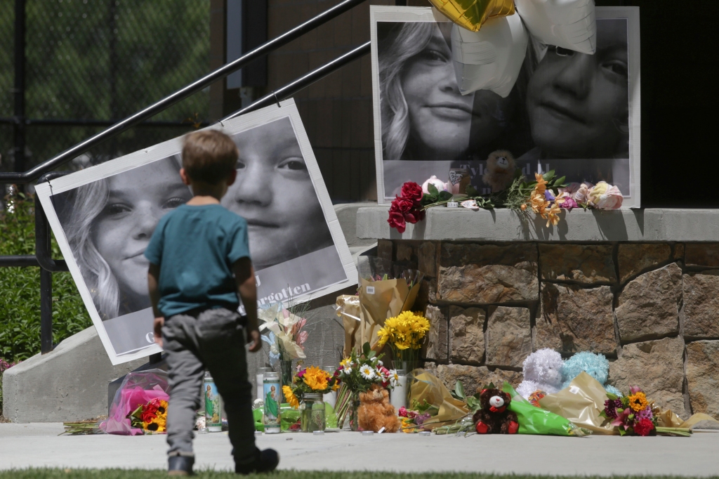 A boy looks at a memorial for Tylee Ryan and Joshua "JJ" Vallow in Rexburg, Idaho, on June 11, 2020.