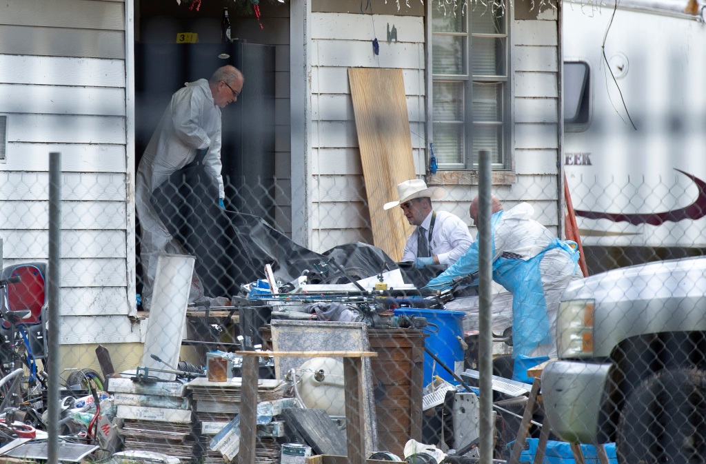 Law enforcement authorities removing bodies from a scene where five people were shot the night before Saturday, April 29, 2023, in Cleveland, TX. A