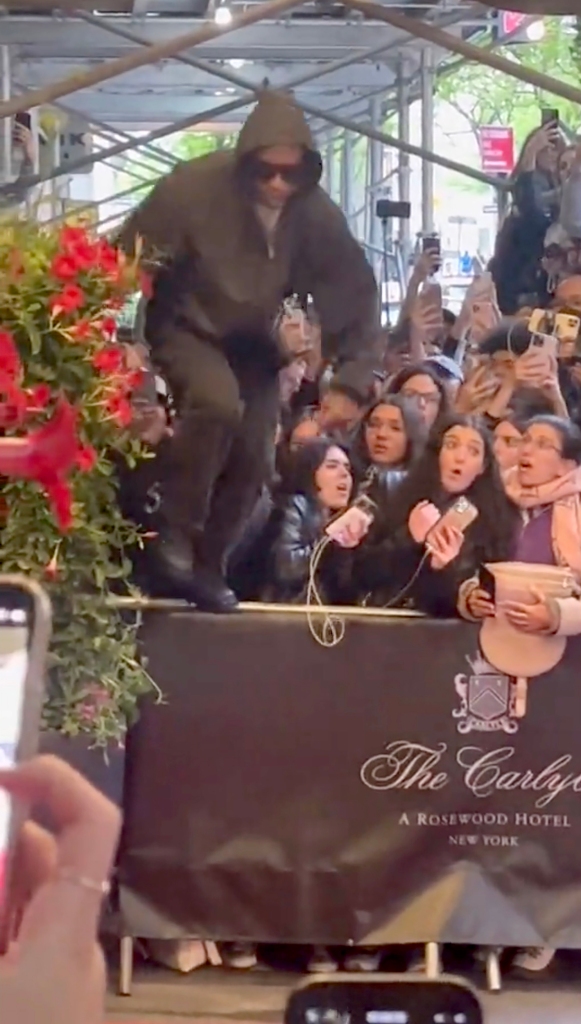 He made his way through the crowd by jumping over the fence. 