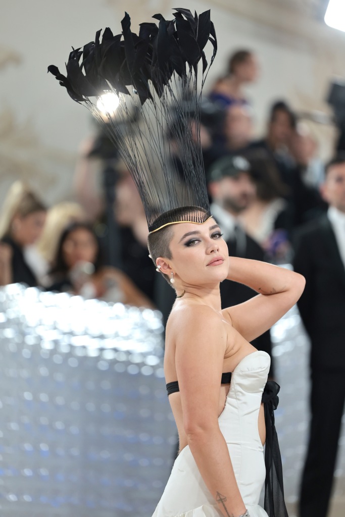 Florence Pugh with shaved head and headpiece on met gala carpet