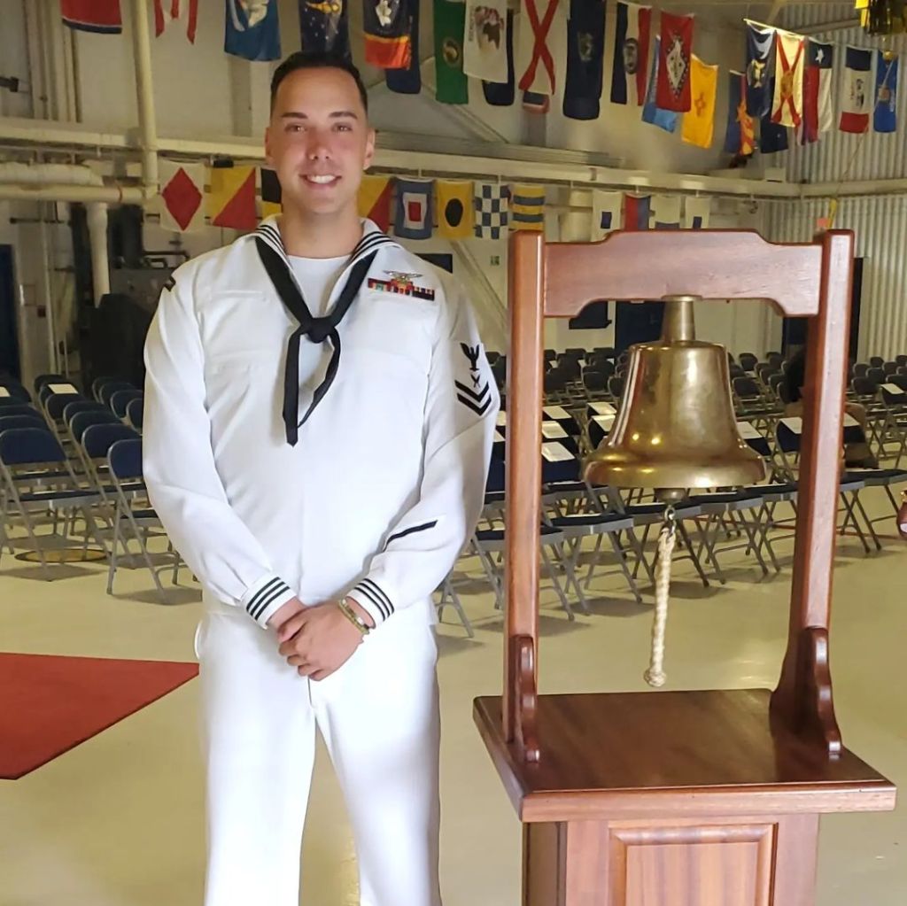 Joshua Kelley in their Navy uniform.