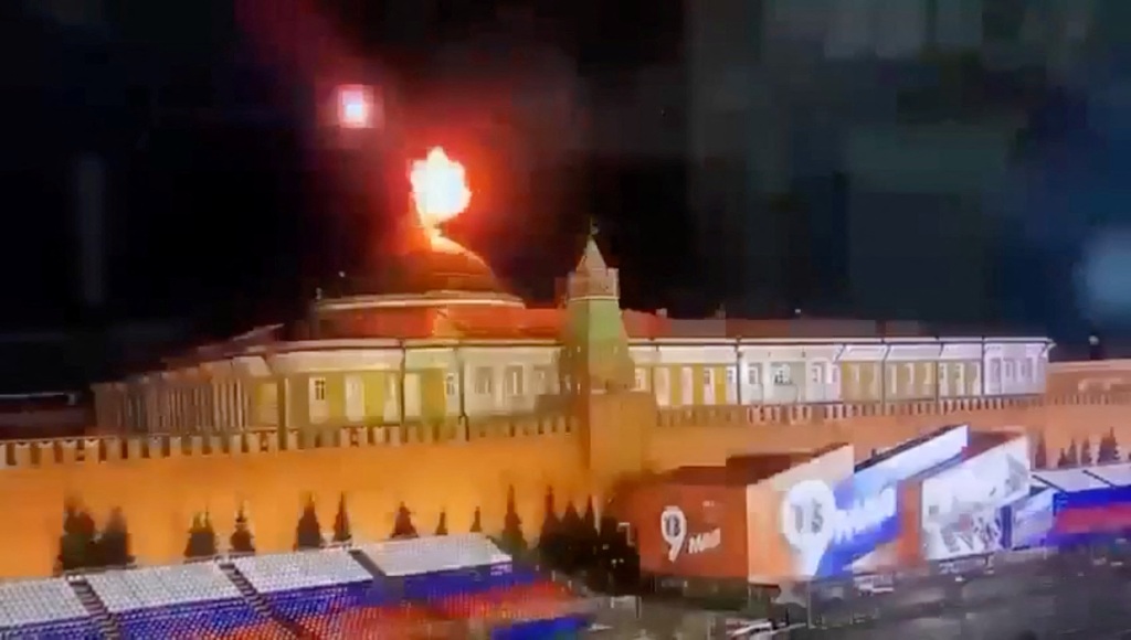 A still image taken from video shows a flying object exploding in an intense burst of light near the dome of the Kremlin Senate building during the alleged Ukrainian drone attack in Moscow, Russia.