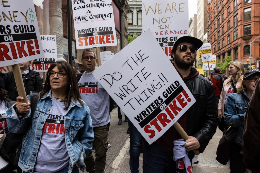 Photos of WGA members striking holding signs.