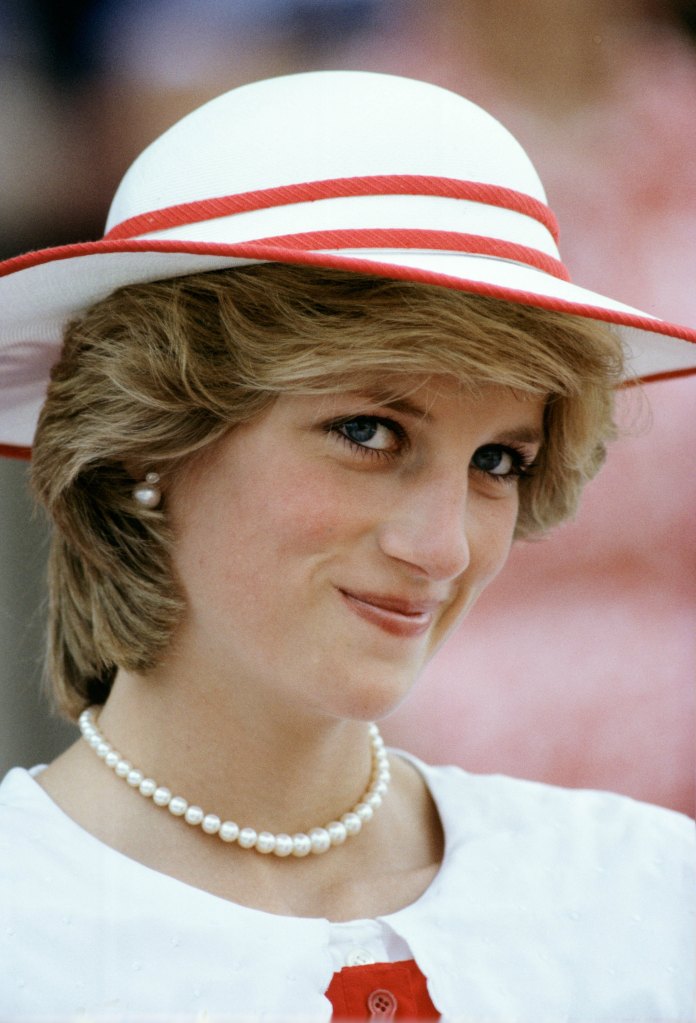 Diana wearing white wearing a pearl necklace.