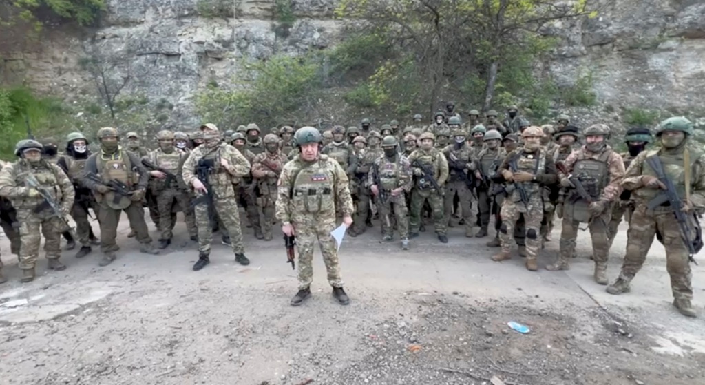 Founder of Wagner private mercenary group Yevgeny Prigozhin makes a statement as he stand next to Wagner fighters in an undisclosed location.