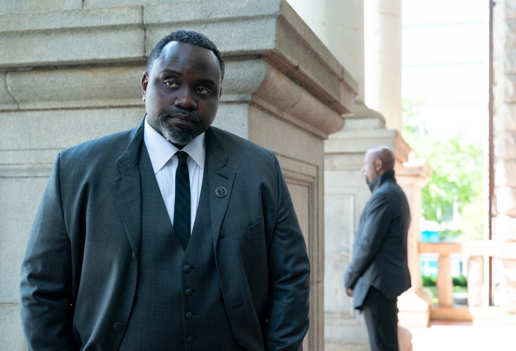 Brian Tyree Henry wearing a suit looking serious. 