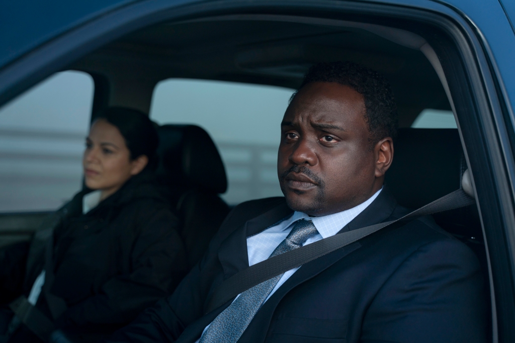 Brian Tyree Henry sitting in a car in a suit. 