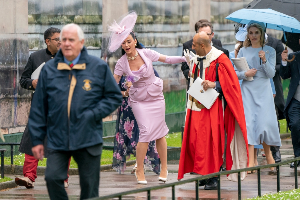 After snapping a few selfies with fans, Perry — dressed head-to-toe in a lilac Vivienne Westwood number — tripped in the wet conditions and almost took a tumble, managing to collect herself in the nick of time. 