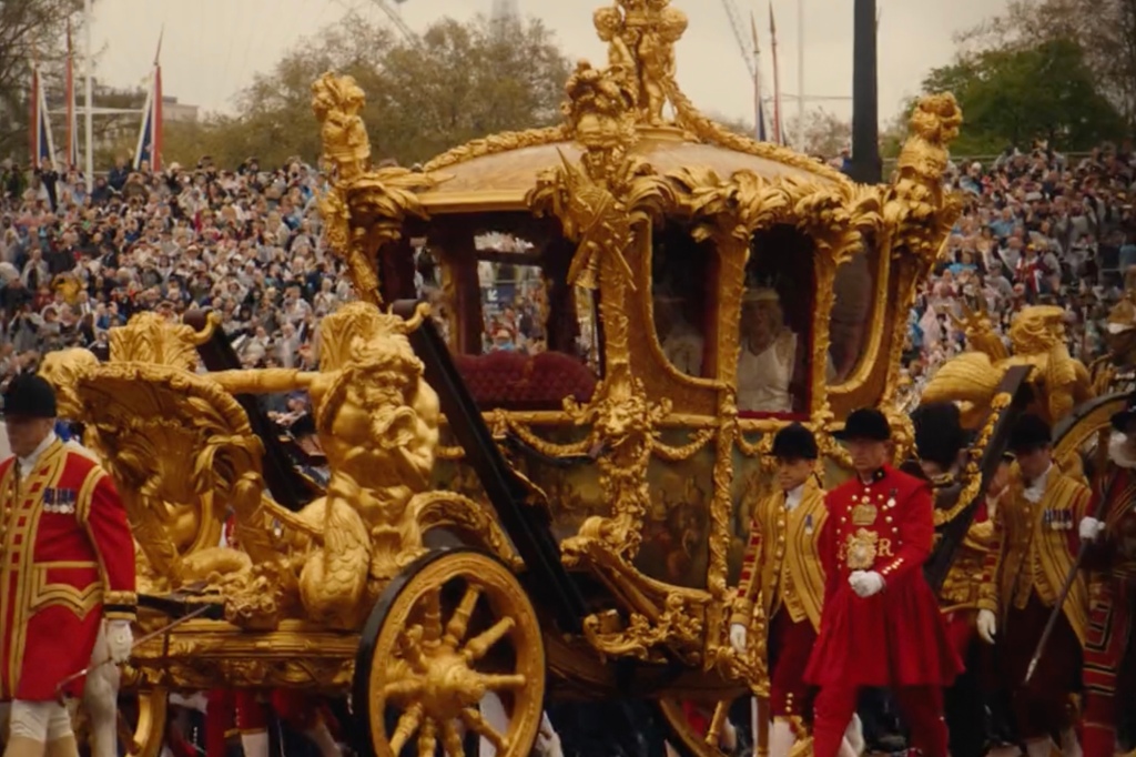 Carriage going down the street during royal procession 