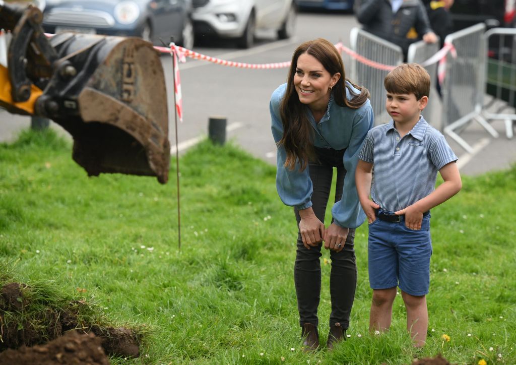 Kate smiles proudly as Louis looks on at the excavator.