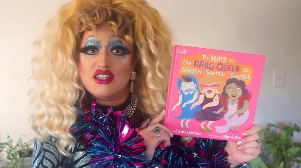 Lil Miss Hot Mess reading a drag queen book