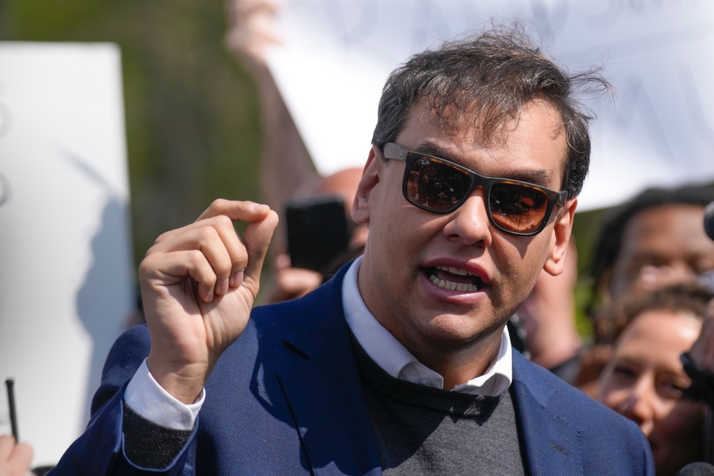 U.S. Rep. George Santos speaks to reporters as he leaves the federal courthouse in Central Islip, N.Y., Wednesday, May 10, 2023. 