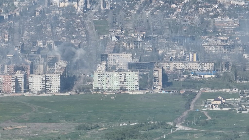 Smoke erupts following a shell explosion, amid Russia's attack on Ukraine, in Bakhmut, Donetsk region, Ukraine in this screengrab obtained from a handout video released on May 7, 2023. 