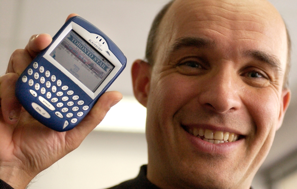 Jim Balsillie, CEO of Research in Motion, creators of the BlackBerry, showing off an early model of the then-revolutionary tool.