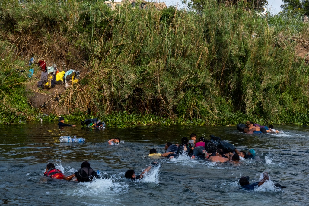 Immigrants swimming to the US.
