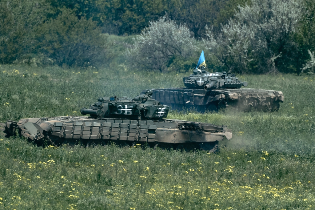 Ukrainian tanks ride near Bakhmut, an eastern city where fierce battles against Russian forces have been taking place, in the Donetsk region, Ukraine, Friday, May 12, 2023.