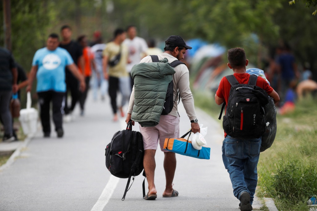 Migrant seeking asylum in the U.S. arrive at a migrant encampment