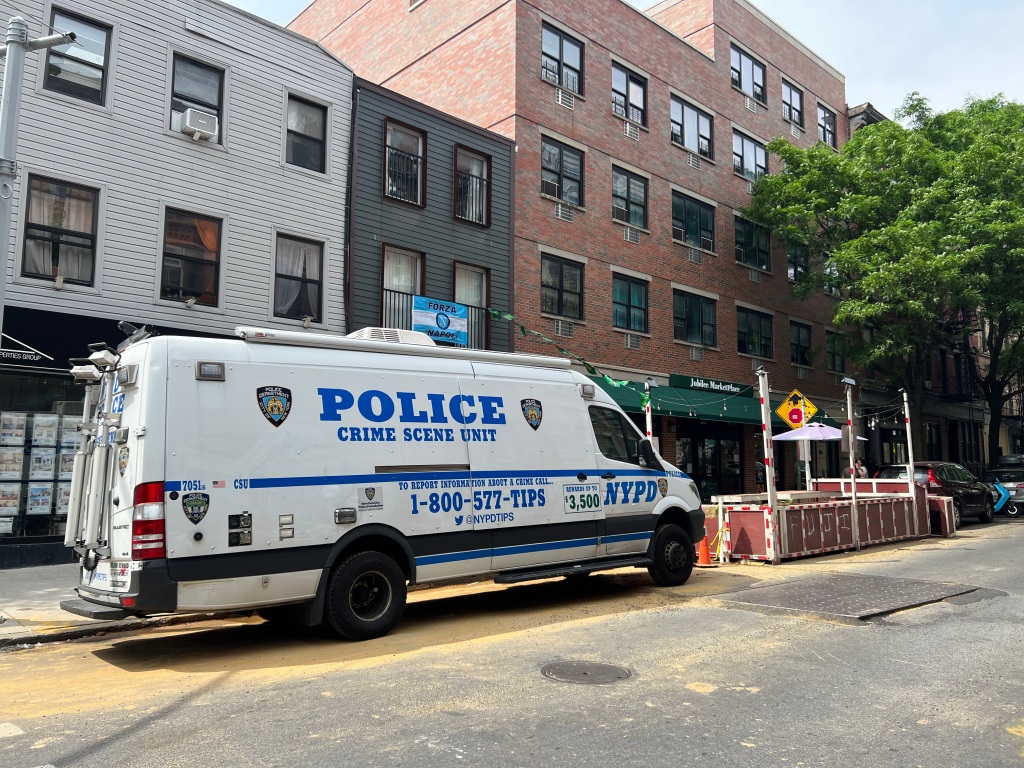 An NYPD van waits outside the Brooklyn home where a woman was stabbed Saturday.