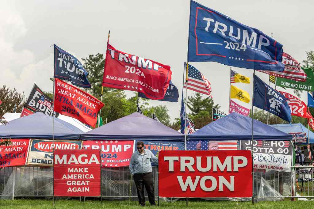 MAGA flags with a supporter standing nearby