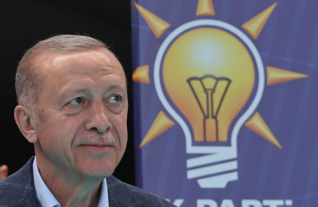 Turkish President Recep Tayyip Erdogan greets his supporters during his election campaign rally.