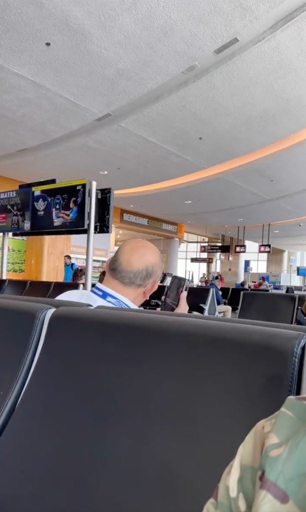 He took video of the back of a man's head talking on speakerphone at the airport. 
